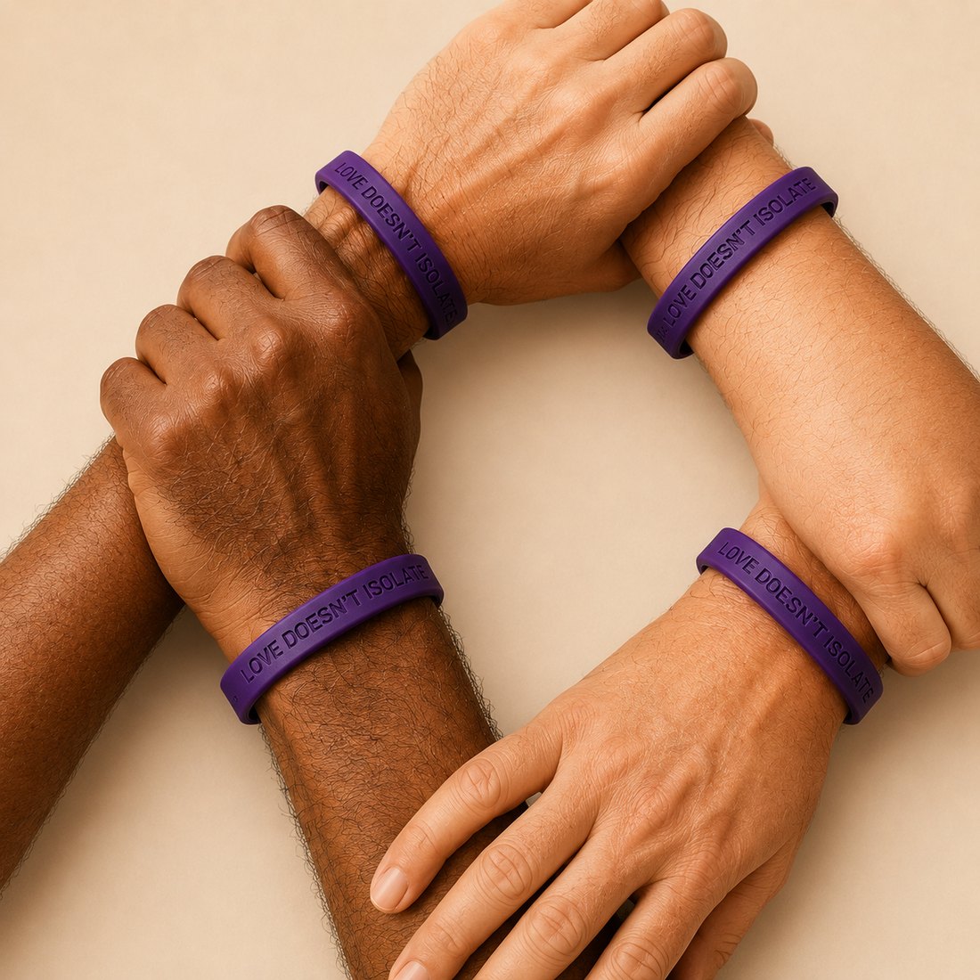 Four wrists of different people, each wearing the purple Love Doesn't Isolate band, forming a circle